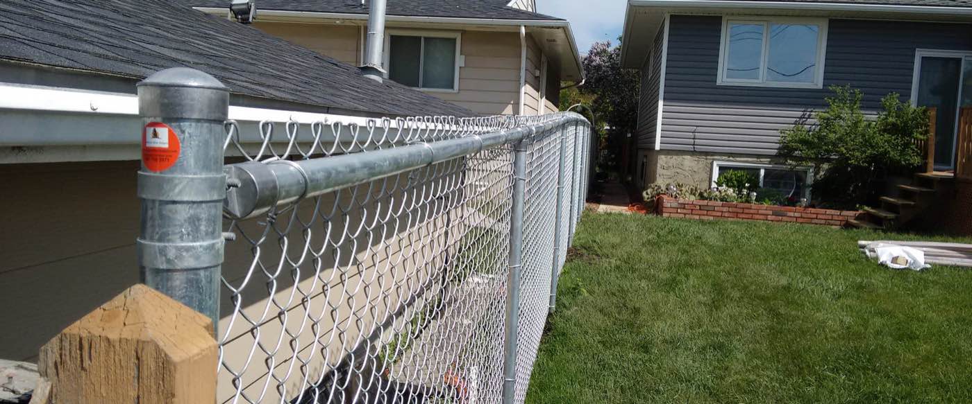 Commercial fence installation with privacy slats in Calgary